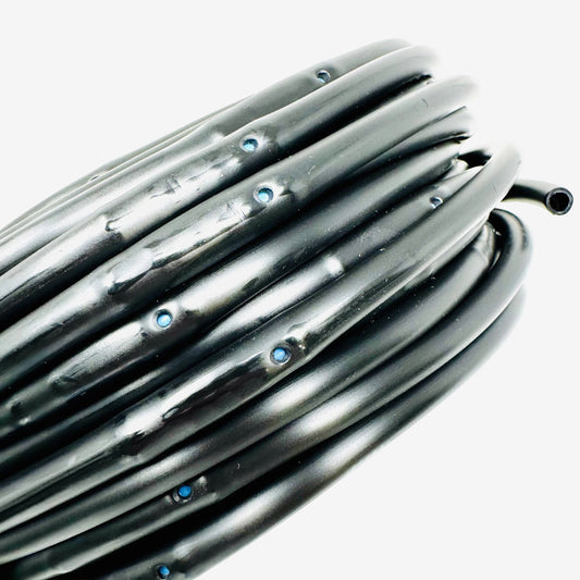 Coiled black dripper line tubing on a white background