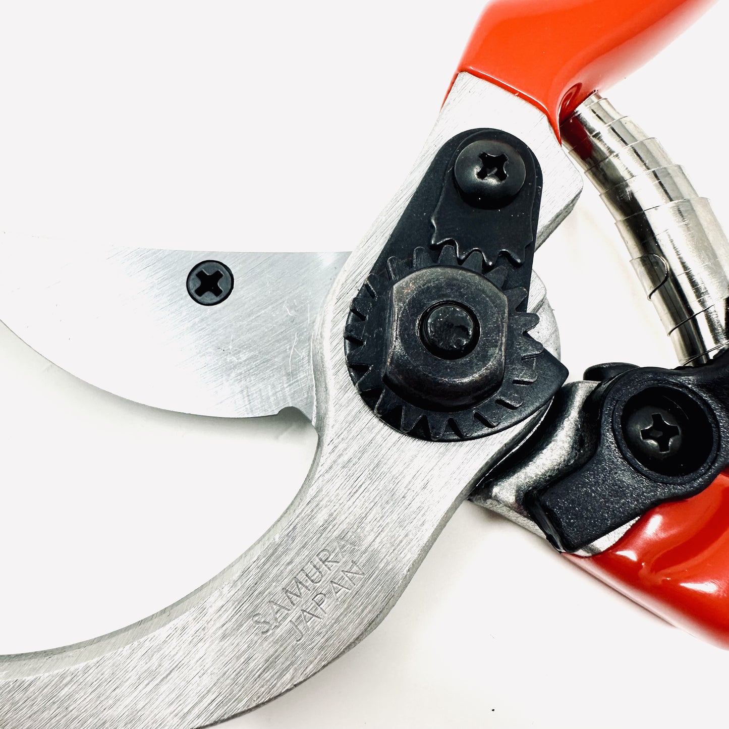 Close-up of a pair of garden shears with a red handle on a white background
