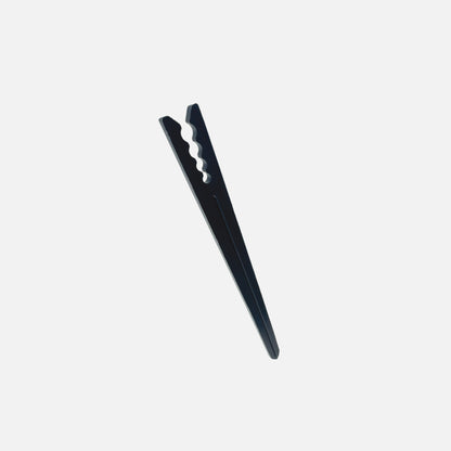 A single black 6" drip tubing plastic support stake designed to hold tubing in place.