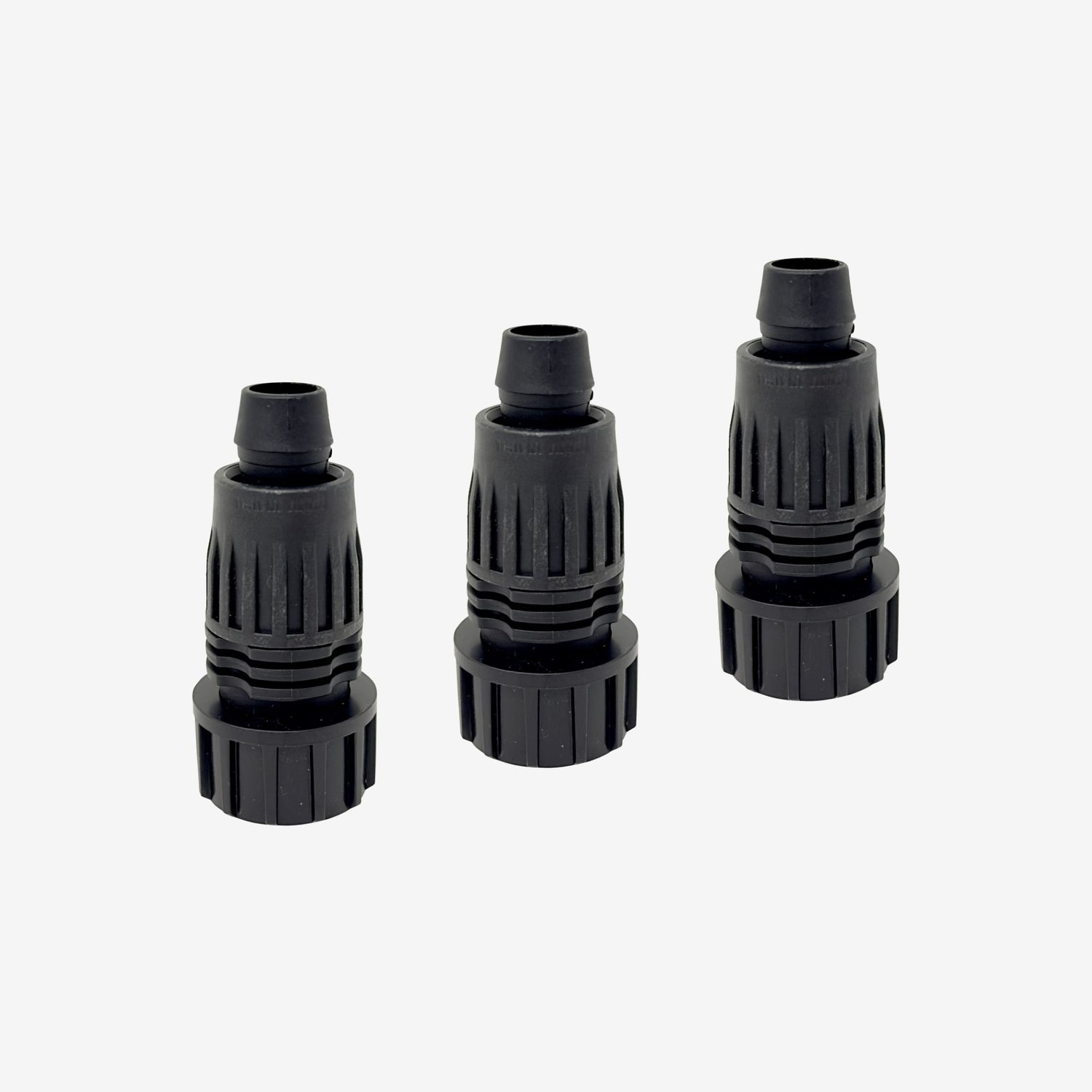 Three black plastic drip tube adapters on a white background