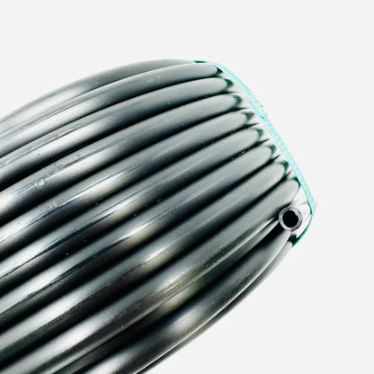 Close-up of a Sprinkland 1/4" drip irrigation tubing on white background. 