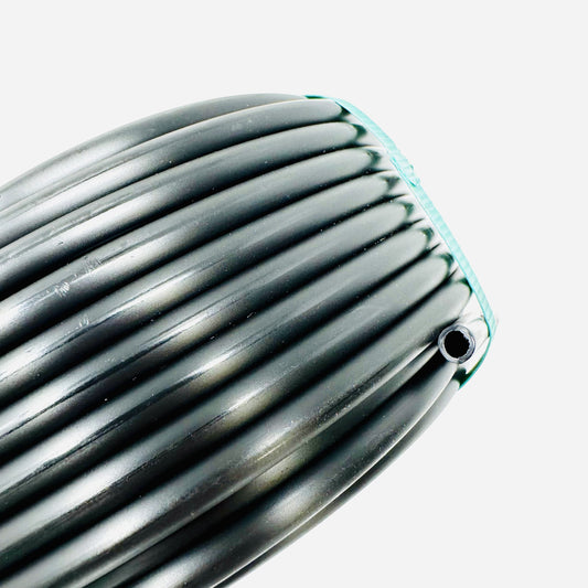 Close-up of a Sprinkland 1/4" drip irrigation tubing on white background. 