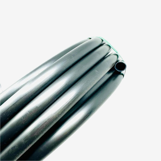 Close-up of a Sprinkland 100 ft coil of drip irrigation supply tubing on a white background